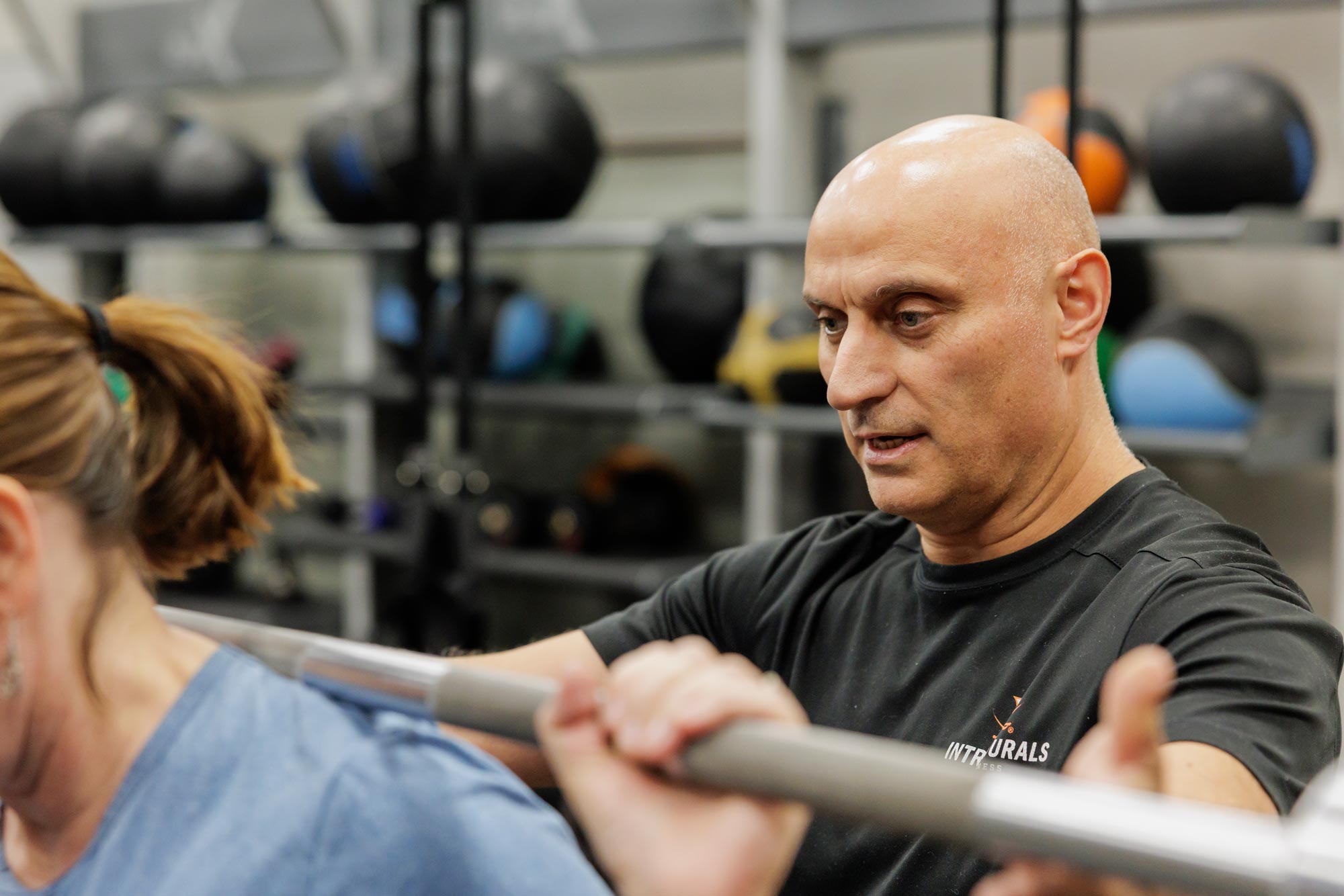 Close up of Jim Karimi spotting a client