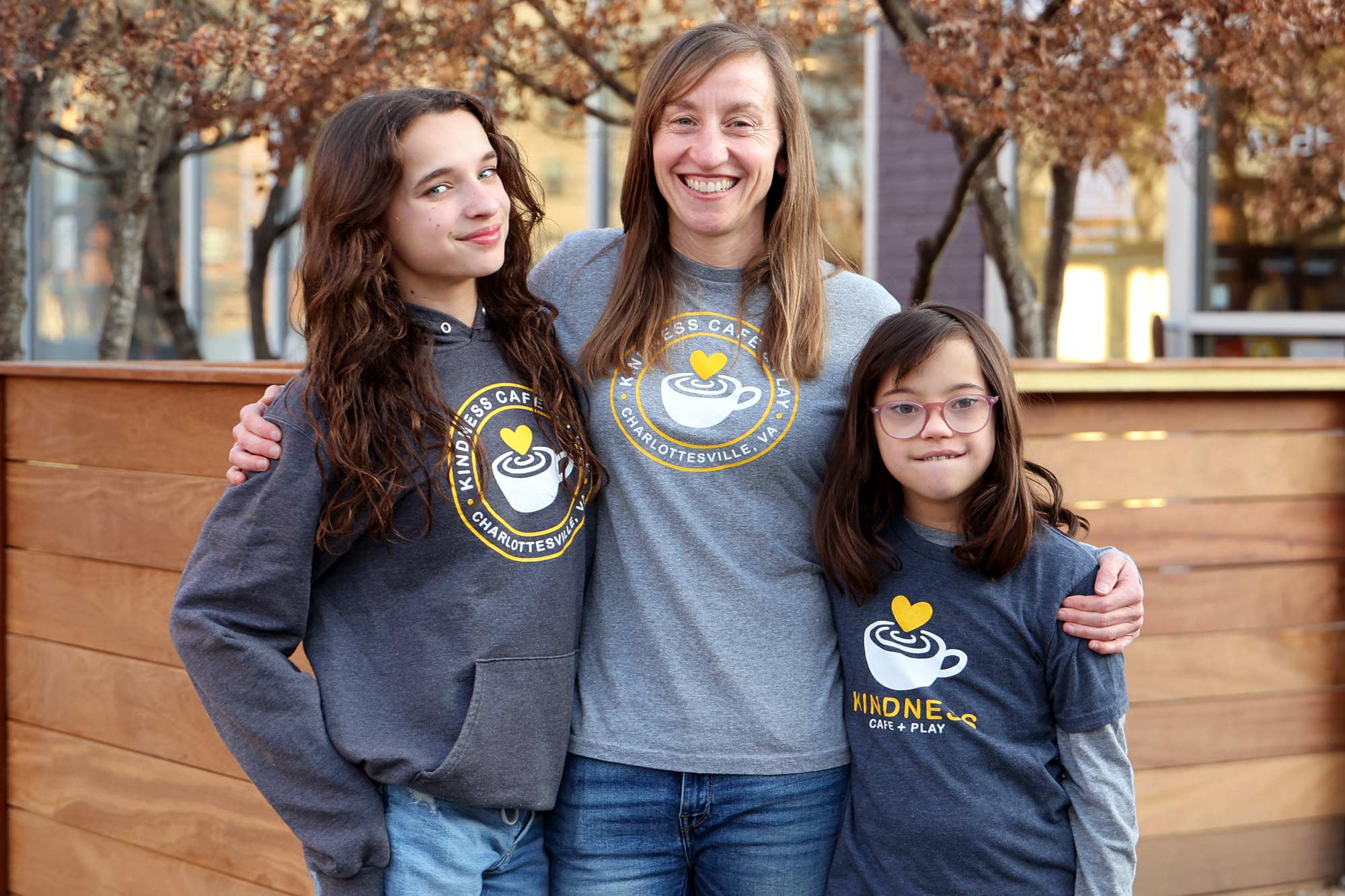 Portrait of Kindness Café + Play founder Katie Kishore in middle and her daughters Mira (left) and Kiran (right)