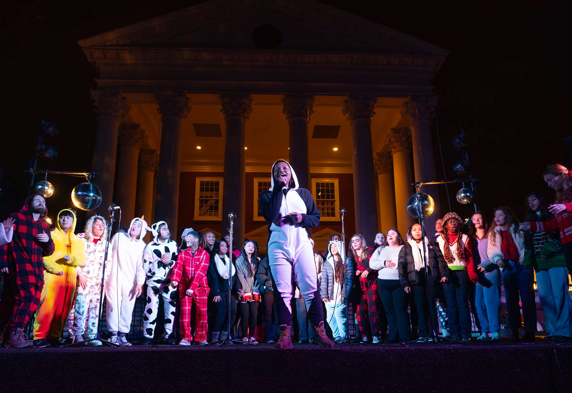 An a capella group sings in their onesie costumes in front of the Rotunda