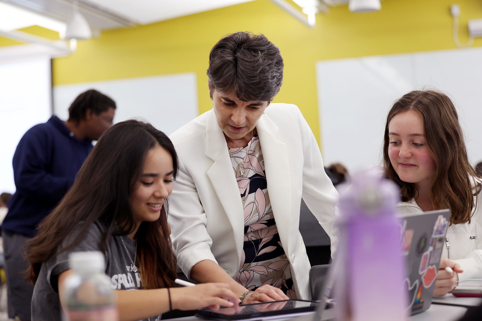 Laura helping a student in the classroom