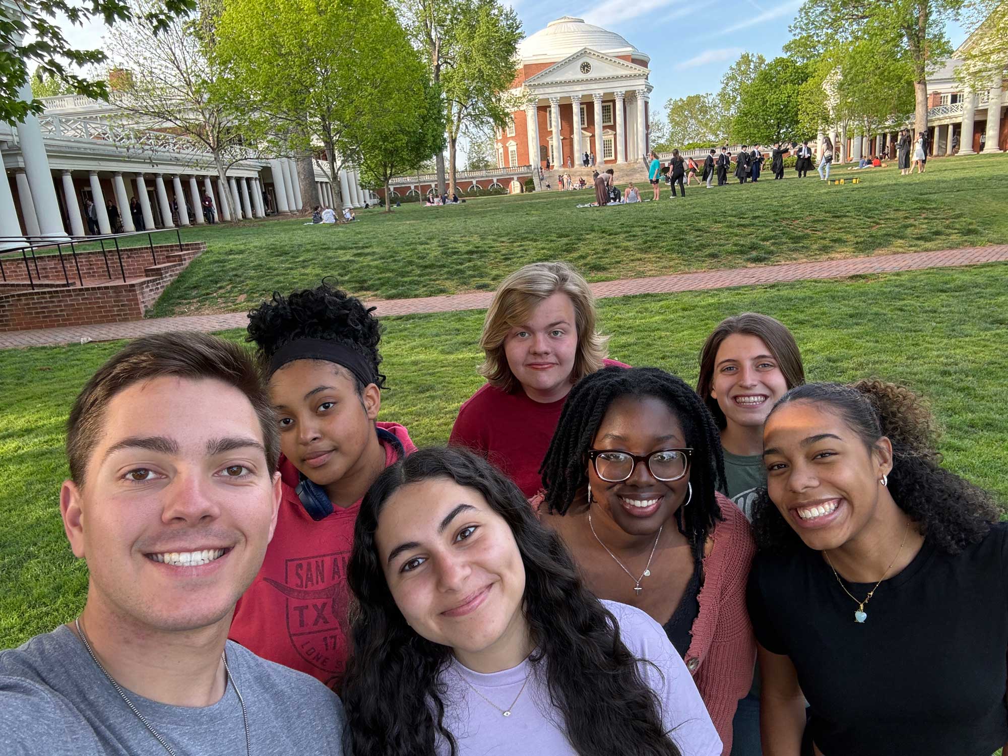 A group of students taking a selfie at a Hoos Connected event on the Lawn in front of the UVA Rotunda