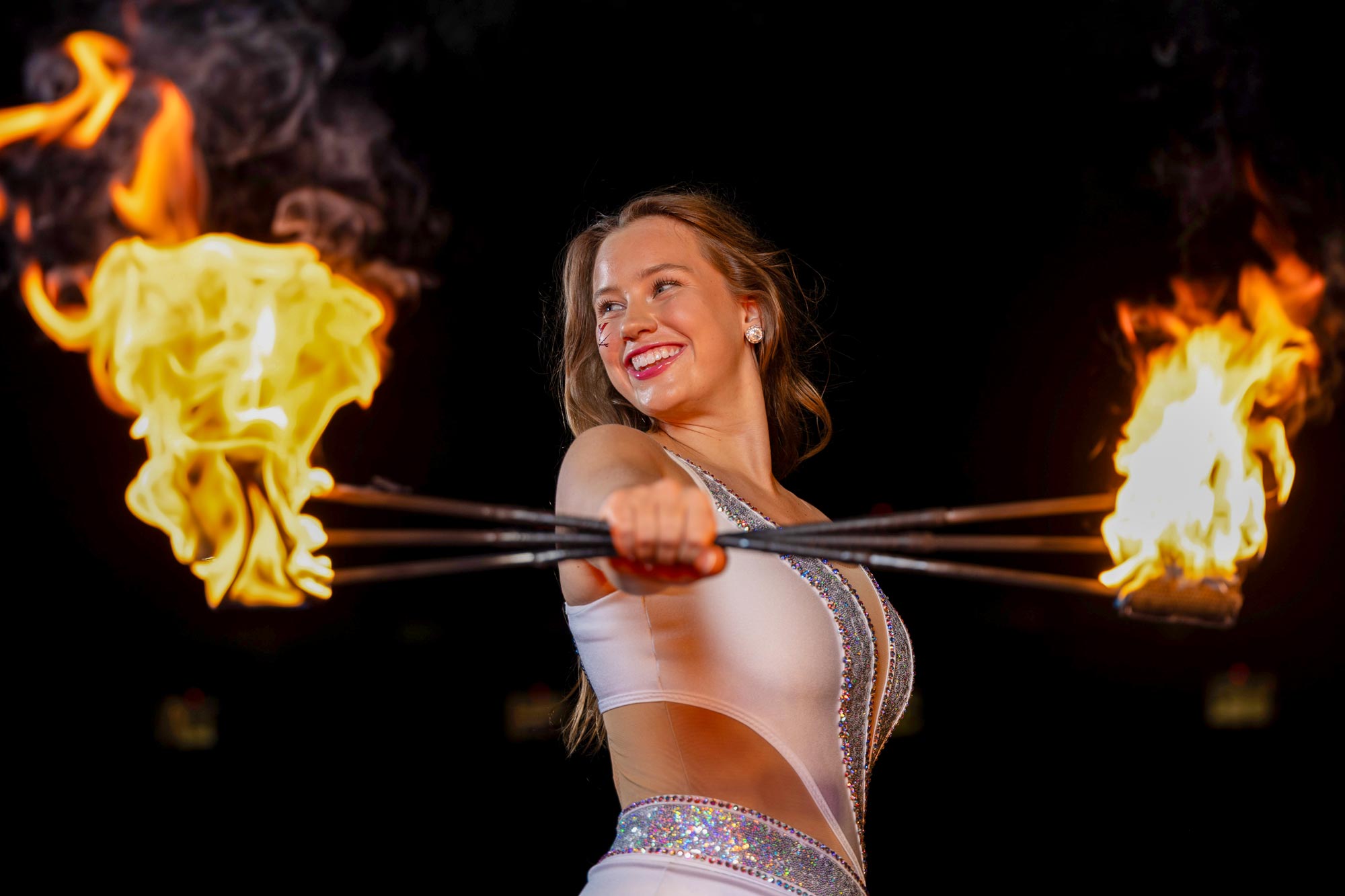 Madison Salber twirling three flaming batons