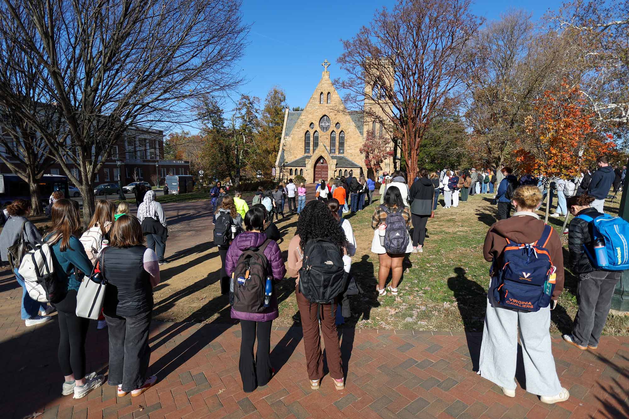A look behind many students, faculty, staff and community members standing outside the UVA Chapel as the memorial bells toll