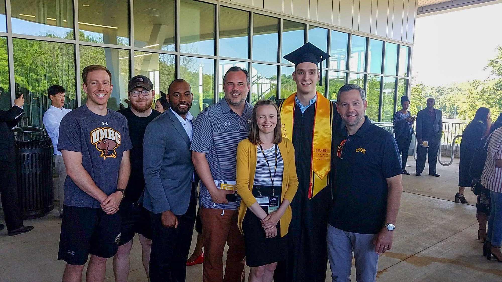 Ryan Odom with Joe Sherburne and his family during his graduation from UMBC