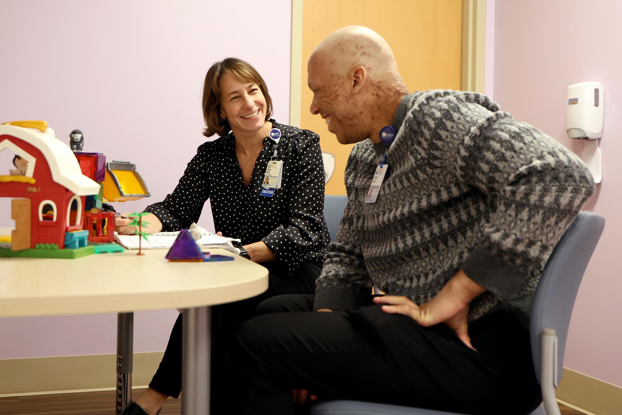 UVA associate professor Alisa Bah working with a patient at a table