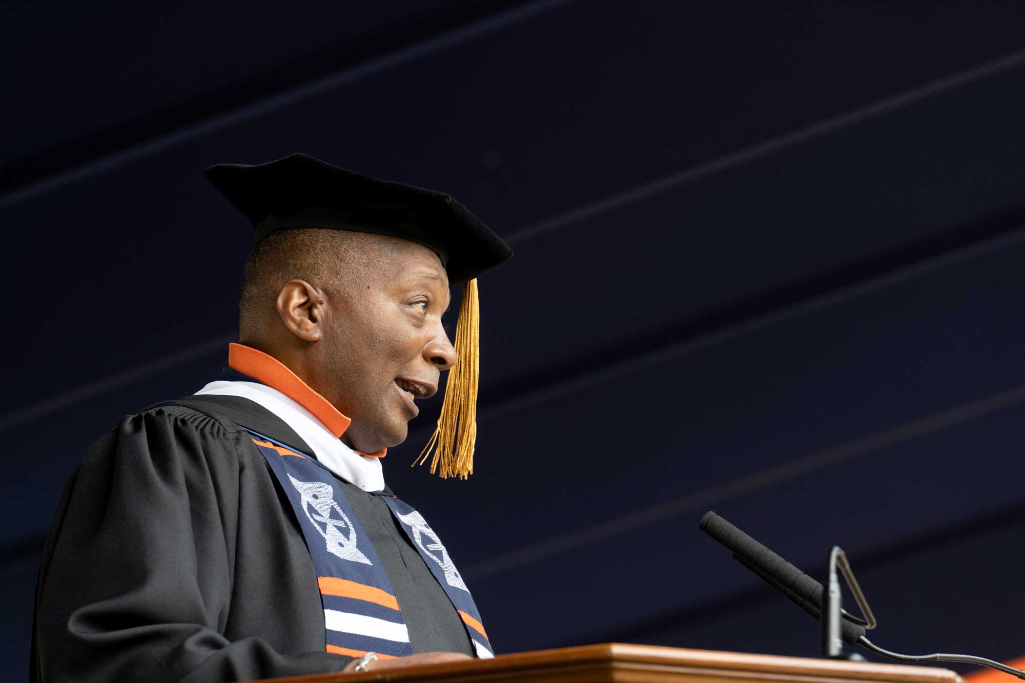 Cedric Rucker at the podium giving the keynote speech at the 2025 Final Exercises ceremony