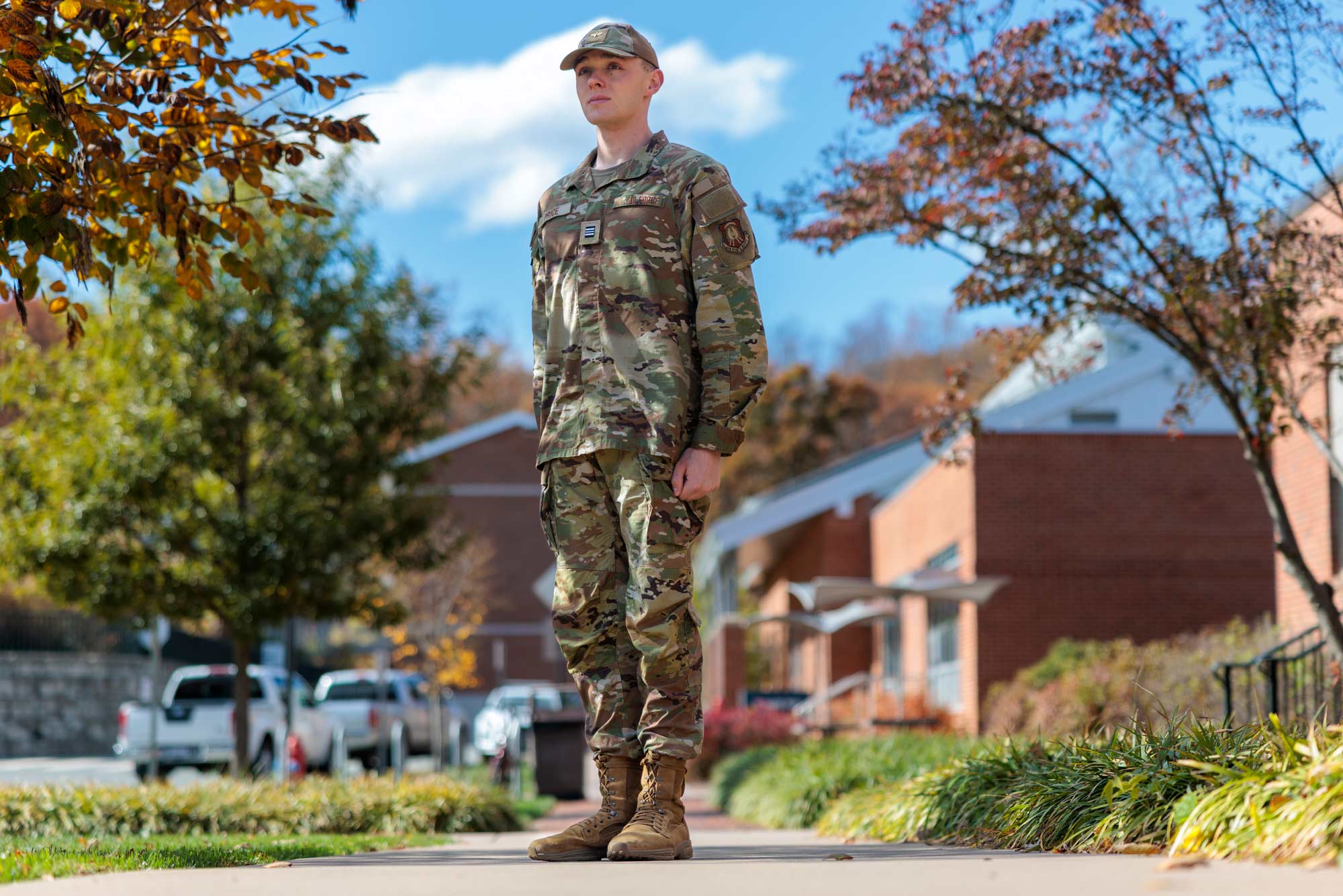 Price standing at attention in his ROTC uniform.