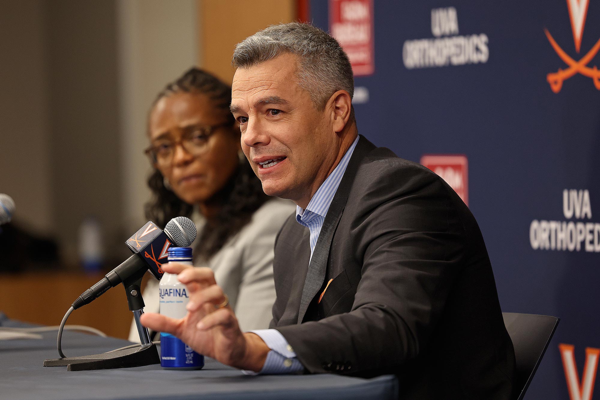 A side view of Tony Bennett sitting next to Carla Williams