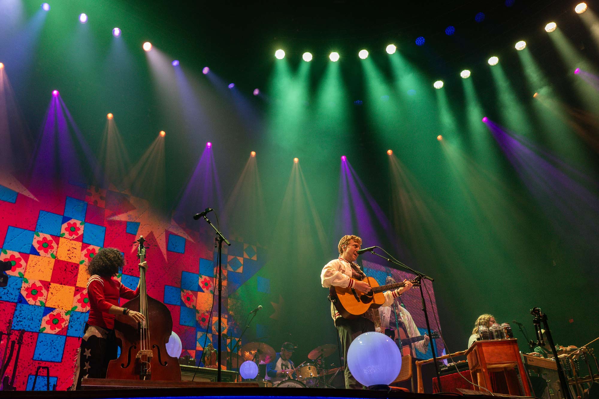 Tyler Childers and the Food Stamps performing in front of a quilted projection image at UVA's John Paul Jones Arena
