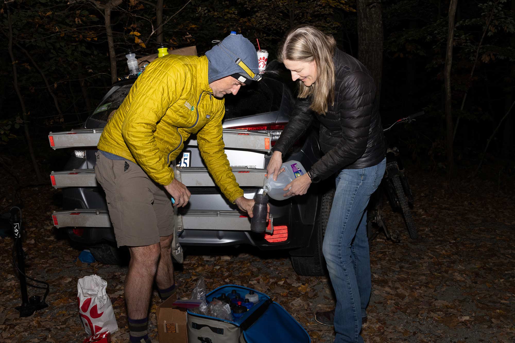 Sam Lindblom and Annette Dusenbury, friends from the Charlottesville Area Mountain Bike Group, filling a water bottle