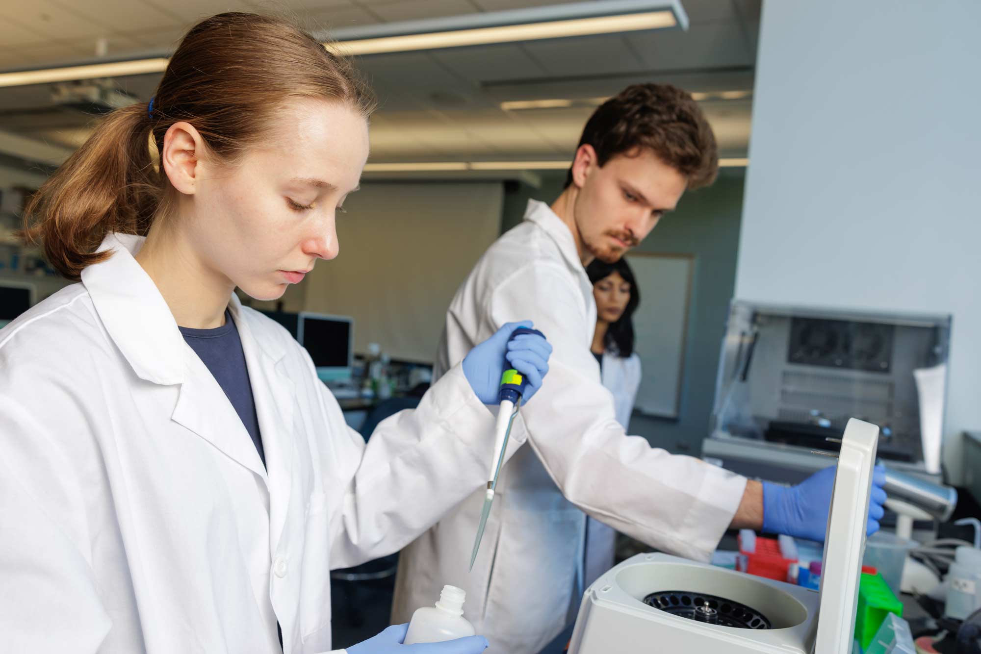 Nichols and Zach Smith fill samples to place in a centrifuge.