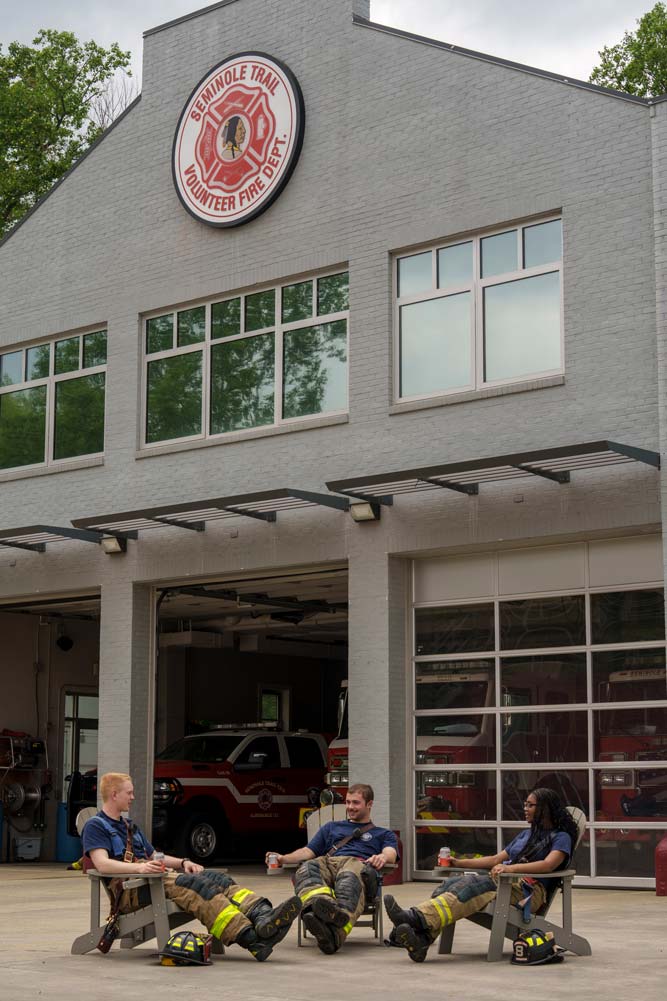 Portrait of Holcombe, Green and Jones enjoy a soft drink and down time after their firefighter training.