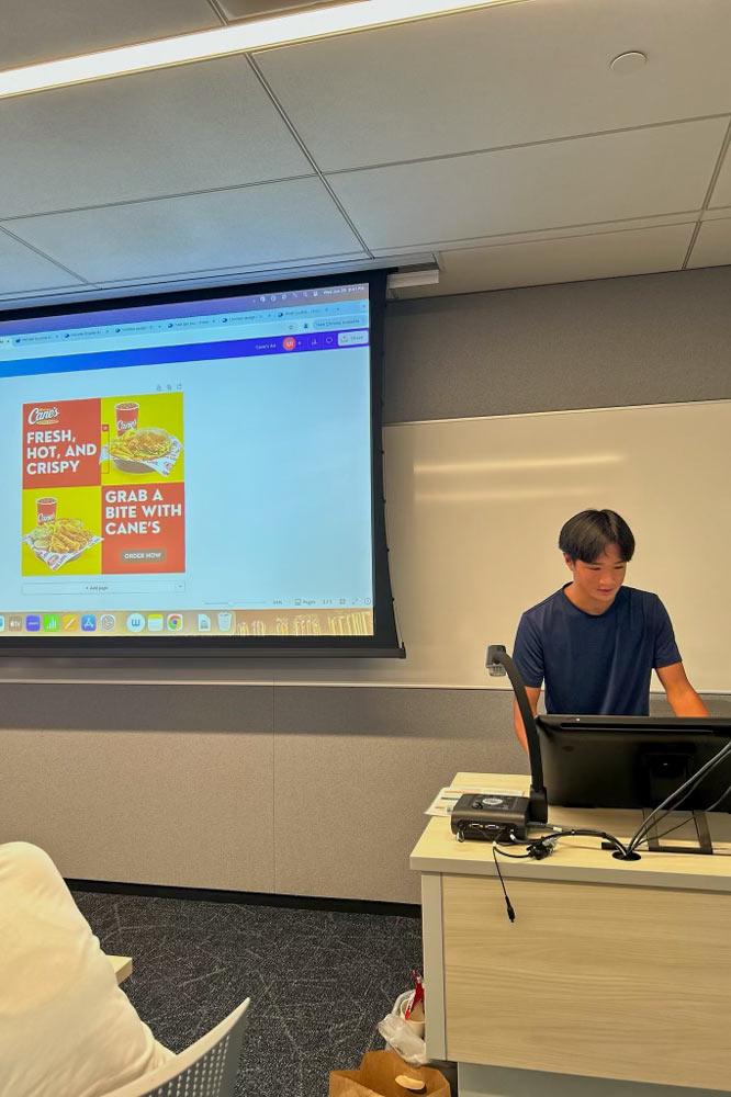 Jason Ho giving a powerpoint presentation on marketing