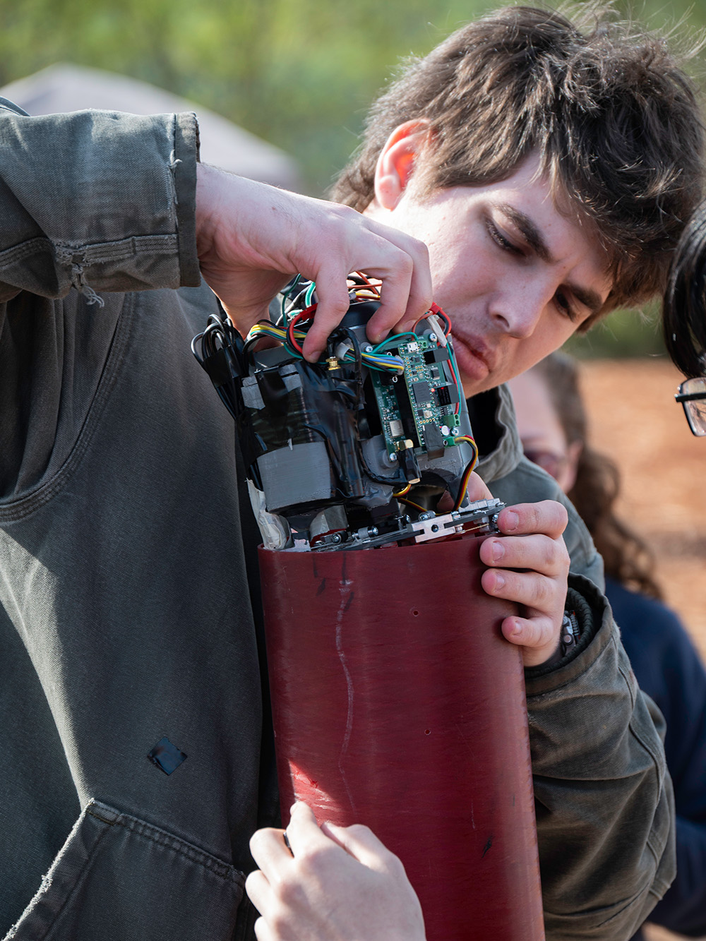 Garner fitting an airbrake onto his rocket.
