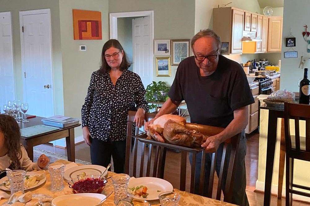 Hosts put a turkey on the table