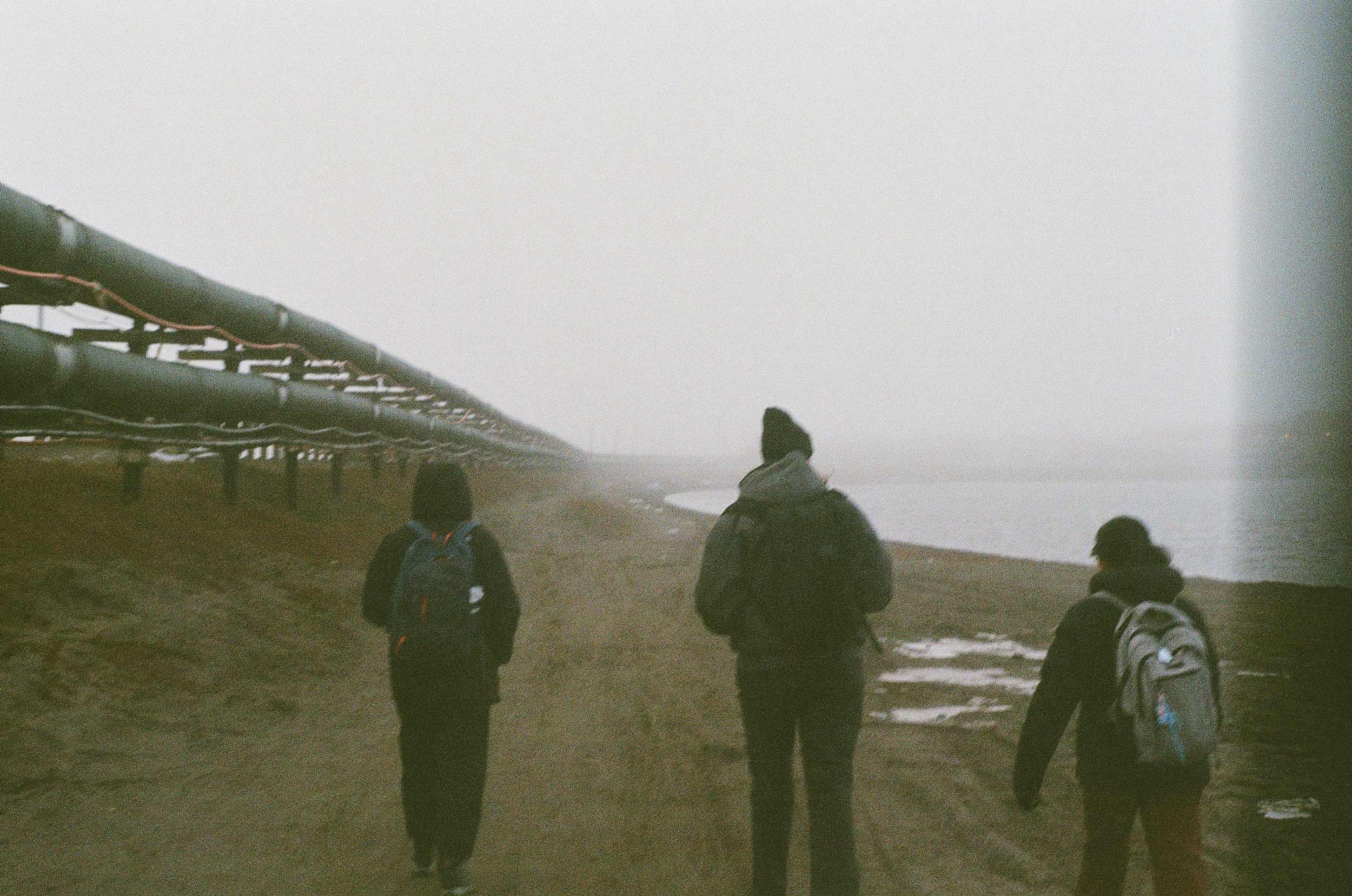 Portrait of people walking in foggy weather.