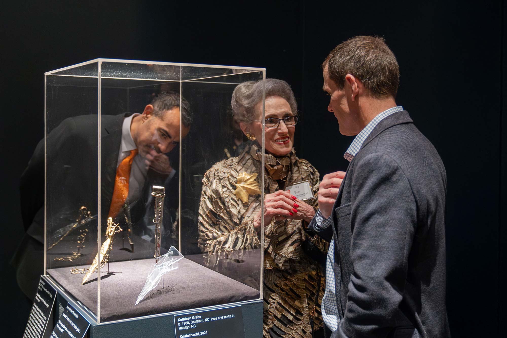 Clay Barr, who donated the collection, gives President Jim Ryan a tour of the exhibition.