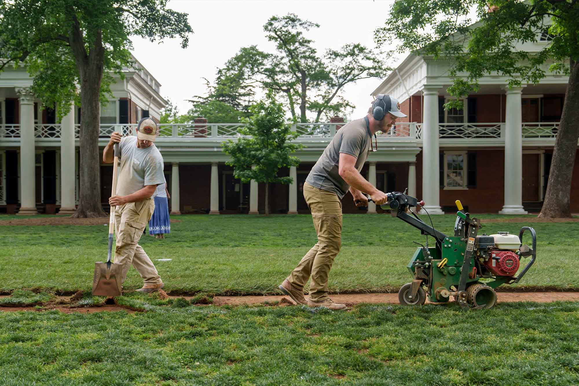 Motto, left, and Leitzel working on the grass on the Lawn