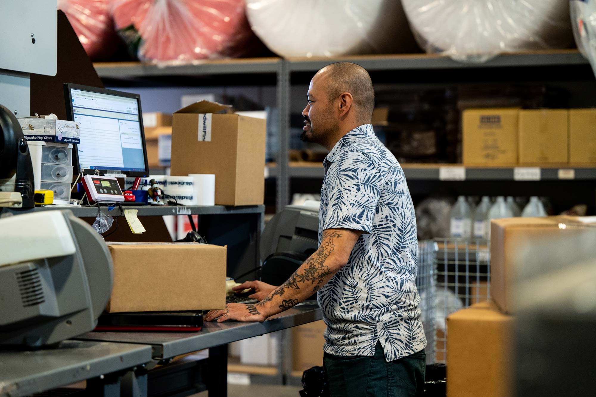 A Goodwill employee packaging products to ship