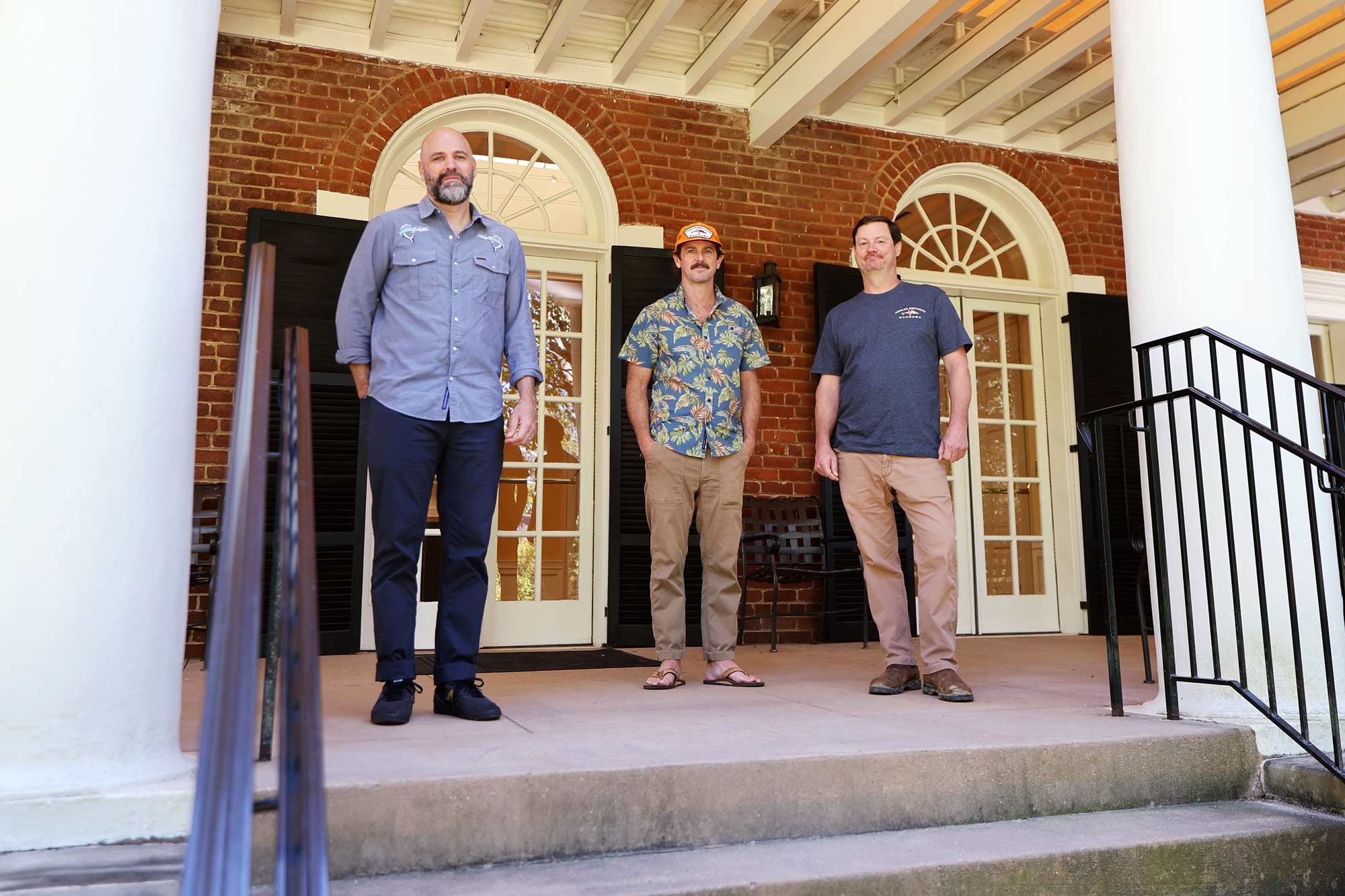 Andy Stepanian, Mason Brent and Chase Heard in 2024 on the porch behind Pavilion VII on the Lawn.