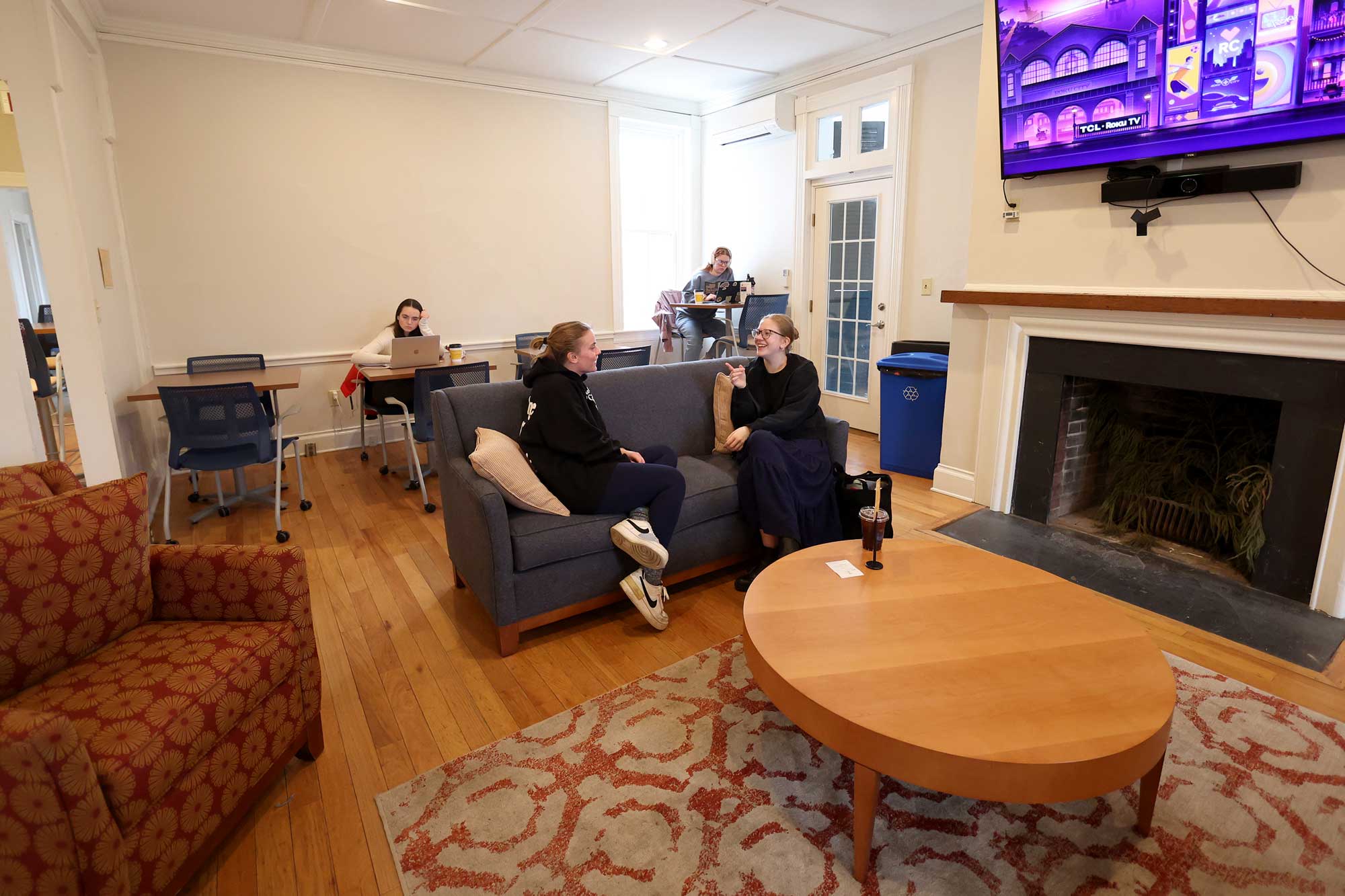 A portrait inside the café, with a student sitting comfortably and studying.