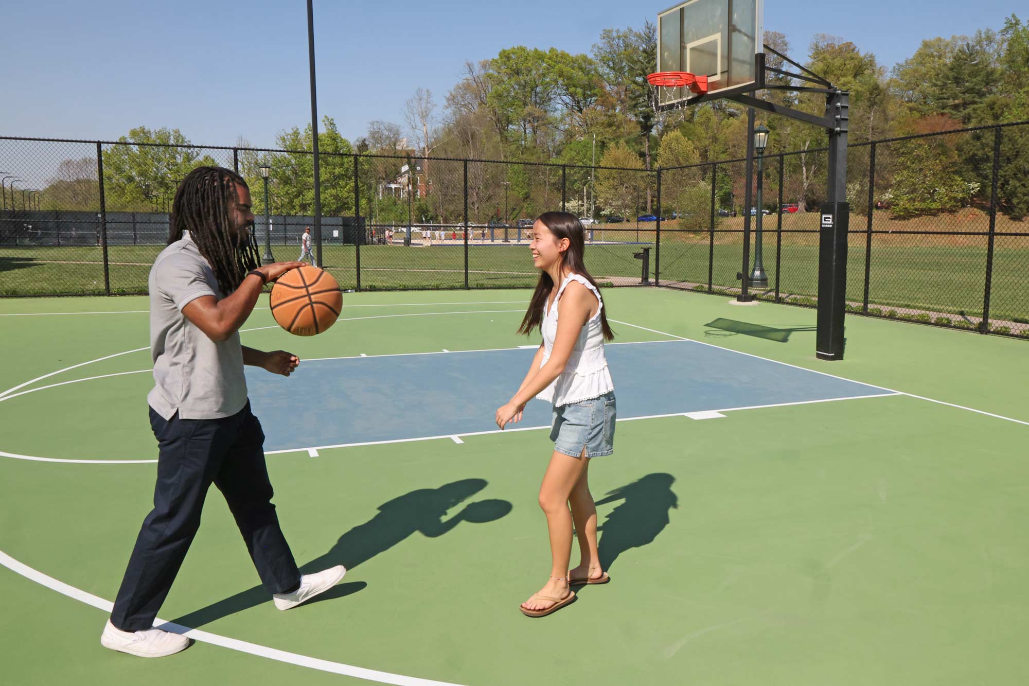Andrew Spencer and SuLing Llanes-Trexler playing basketball