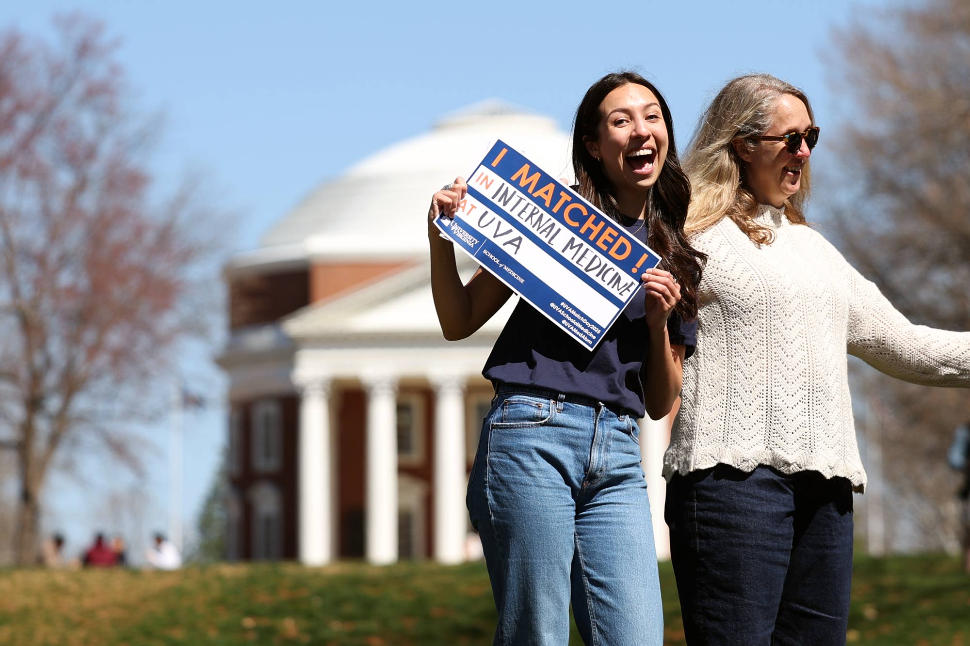 Student holding they Match sign