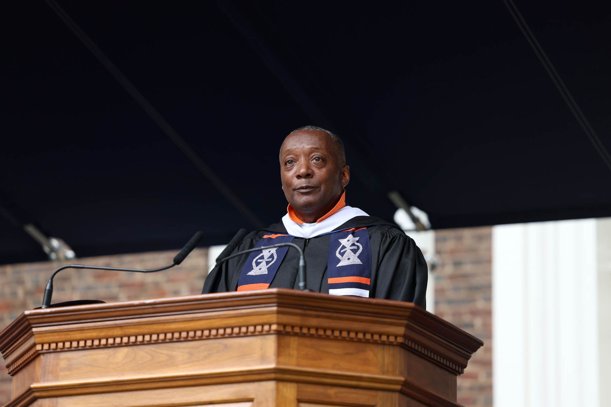 Cedric Rucker speaking at the podium for the UVA 2025 Final Exercises