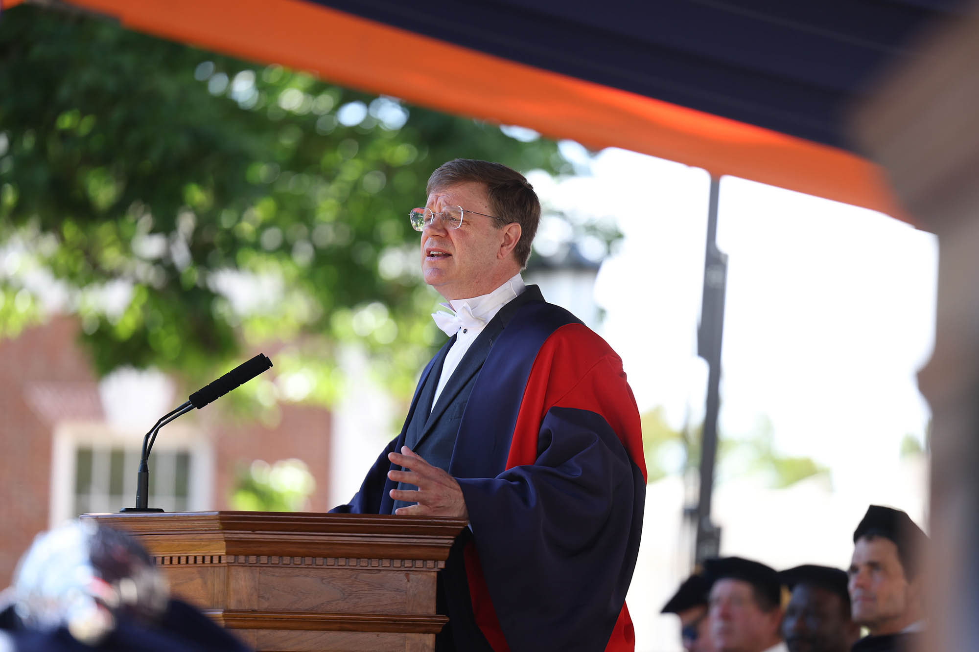 Michael Suarez with graduates in the background making the keynote speech at UVA ”Final Exercises 2025”