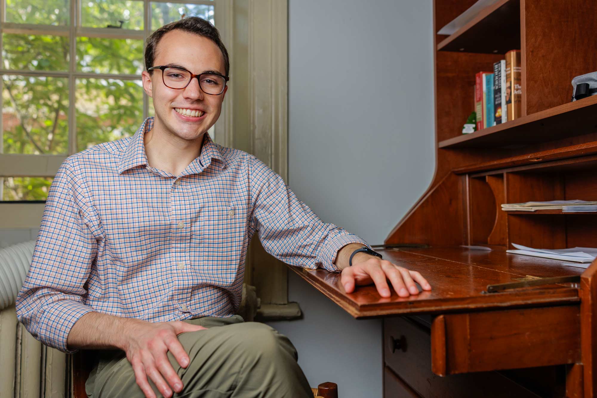 Thomas Ackleson sitting at a secretary in his Lawn room