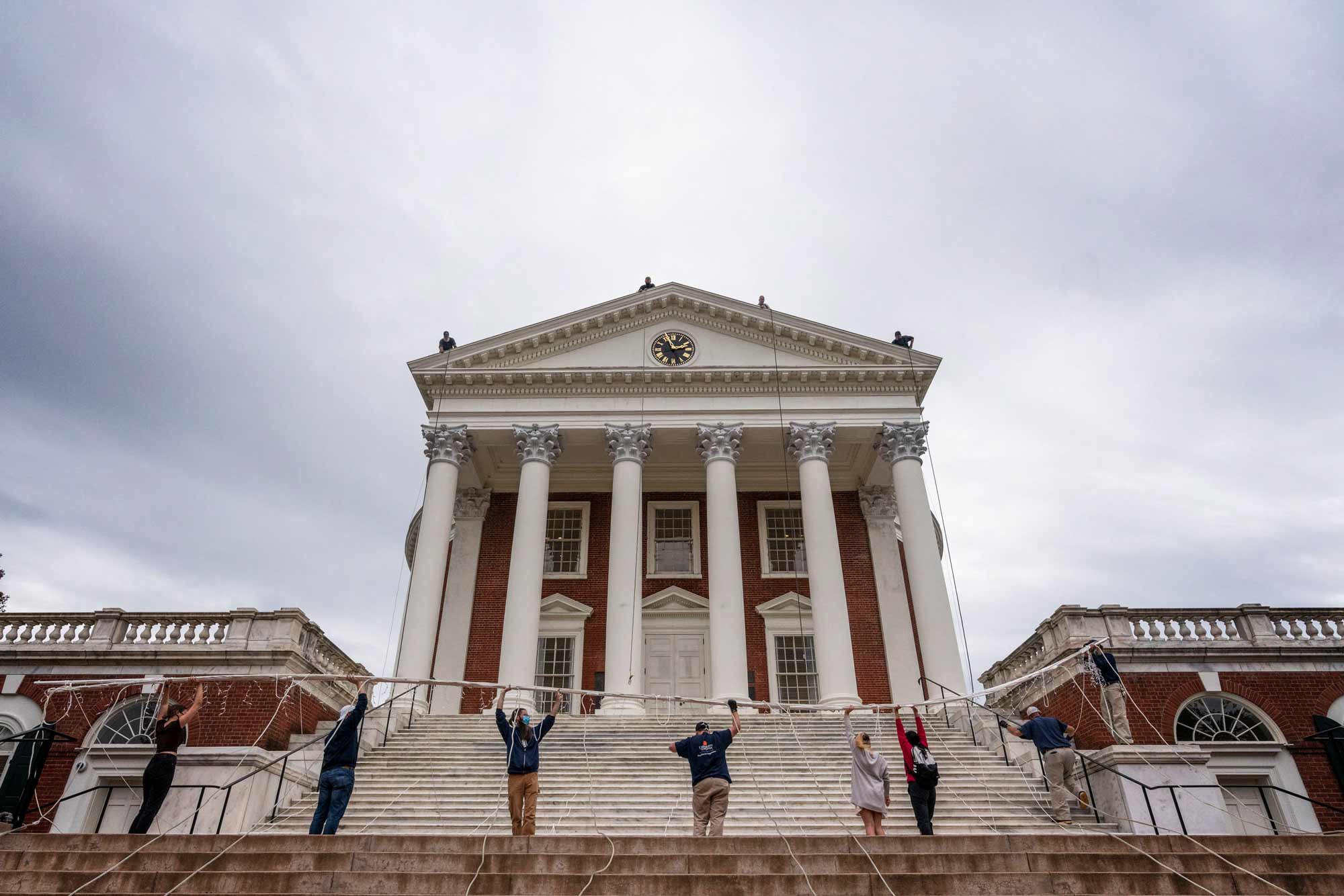 Students and staff working together to hang lights on the Rotunda for the 2020 Lighting of the Lawn