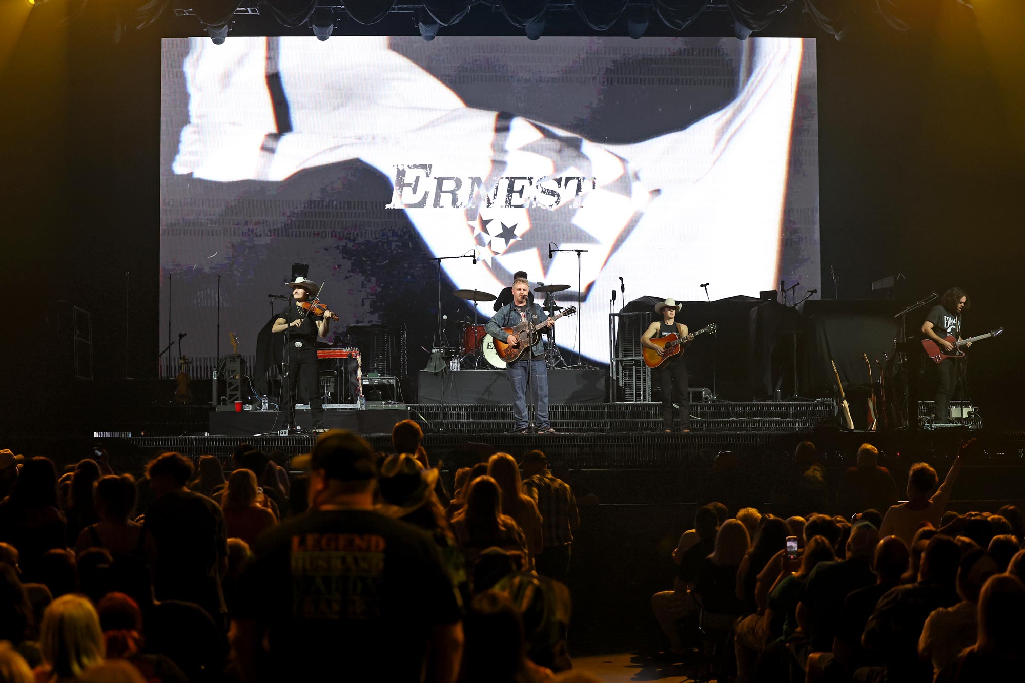 Earnest sings on stage with crowd in the foreground