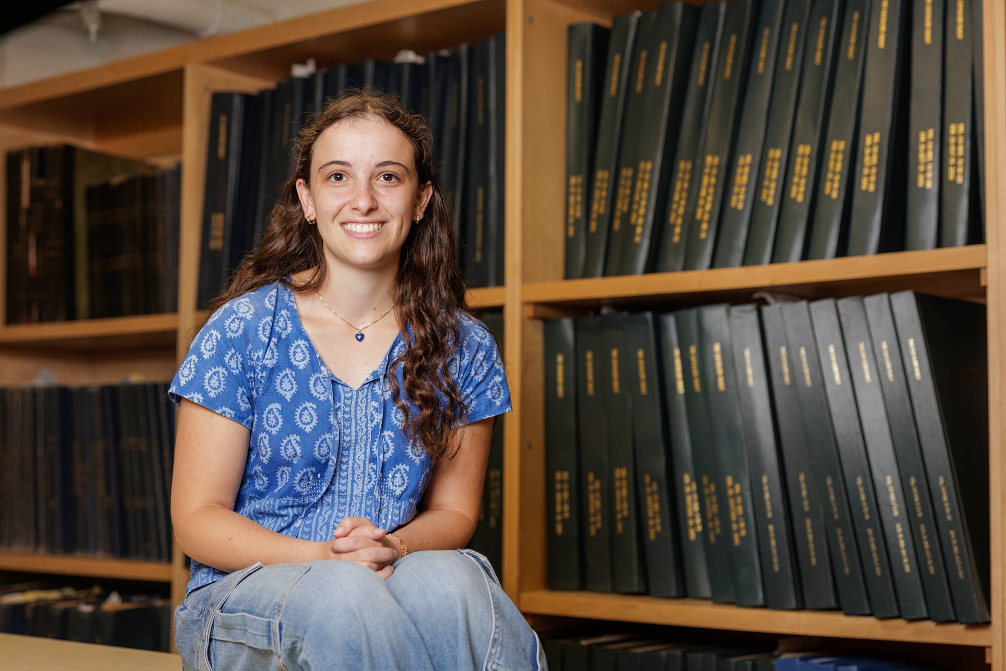 Naima Sawaya sitting in front of the Cavalier Daily archives