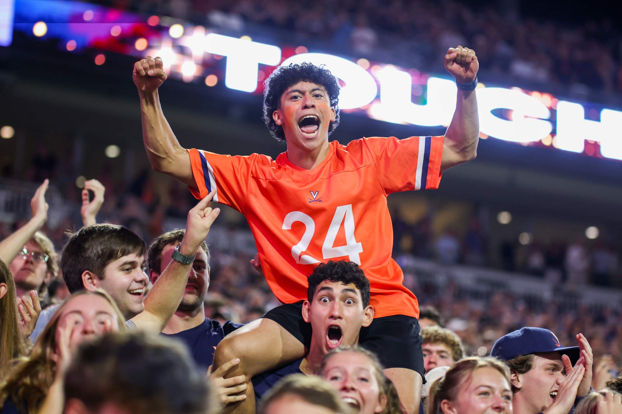 Portrait of UVA fans react to a big play during the win.