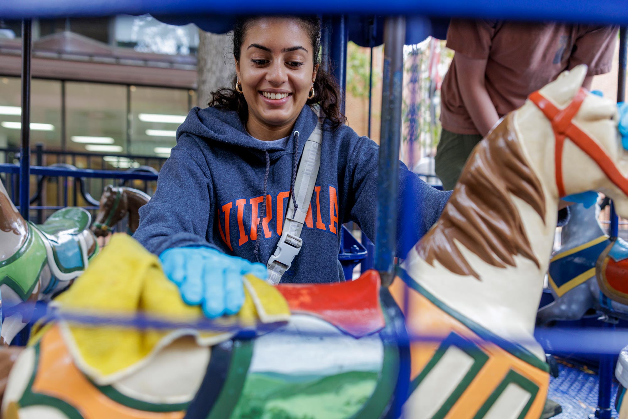 Ria Raval cleaning a carousel horse