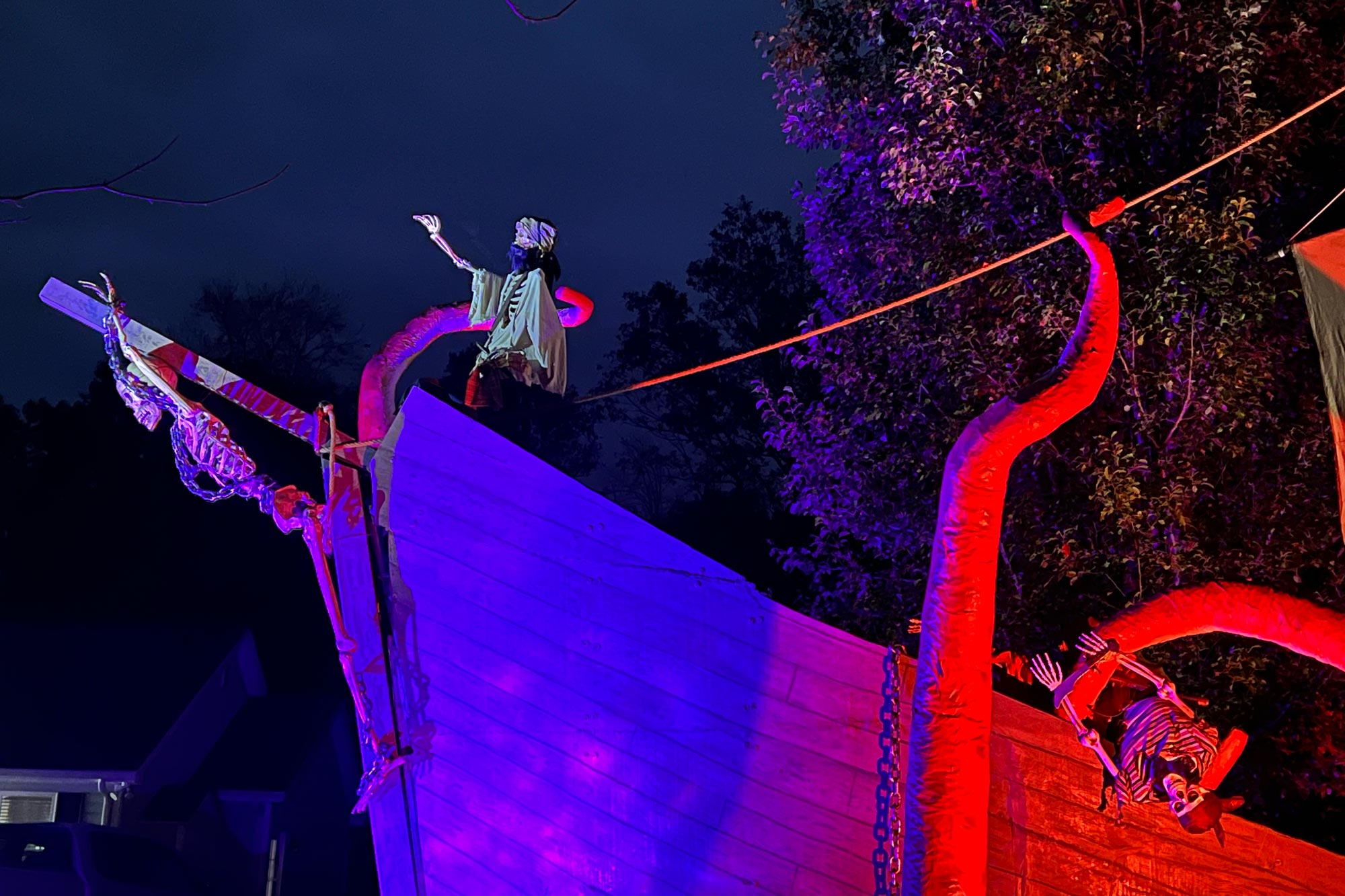 The front of the sinking pirate ship at night.