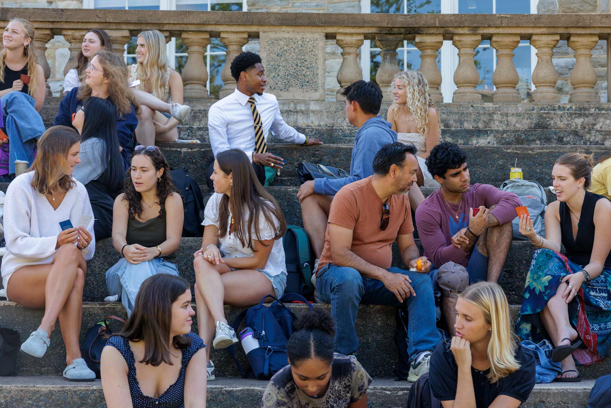 group of people conversing on the steps at UVA