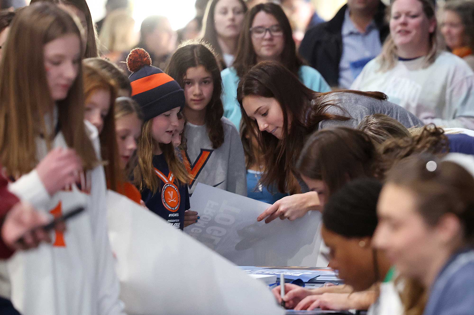 Two-time Olympian and silver medalist swimmer Alex Walsh joins other UVA female Olympians signing autographs after Sunday’s UVA women’s basketball game versus University of Louisville. 