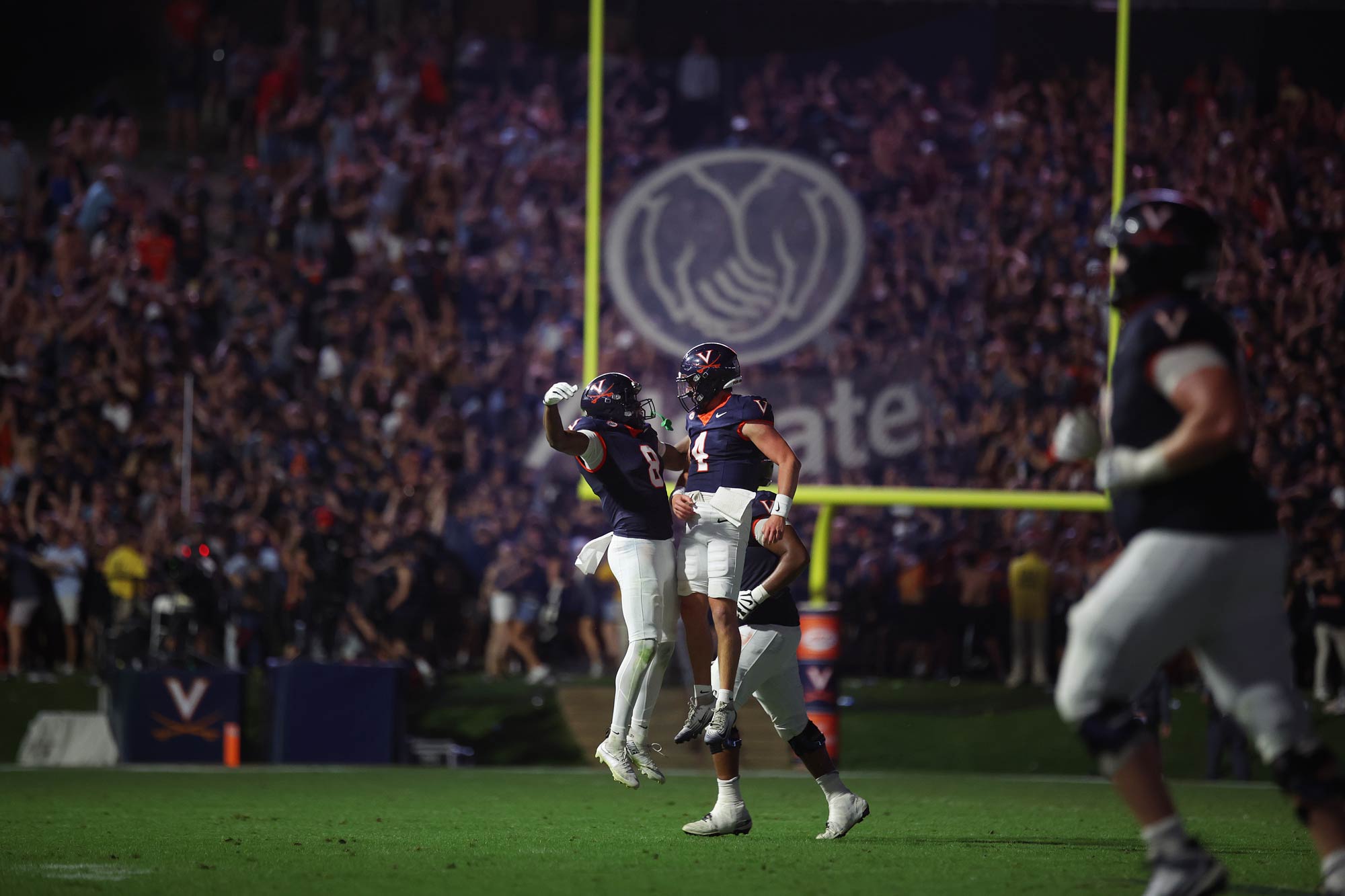 Candid portrait of Morris and Jayden Thomas go airborne to bump chests. 
