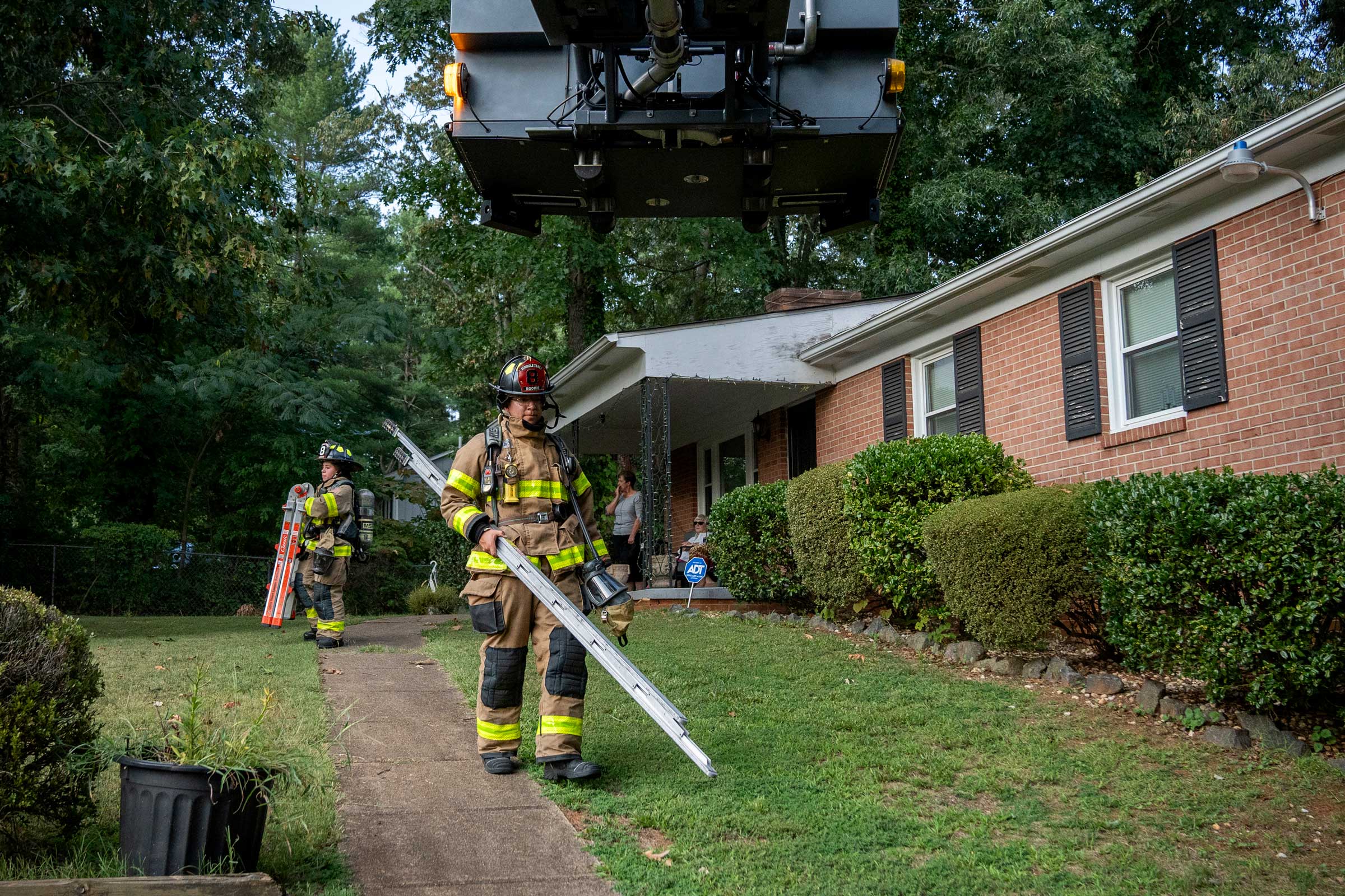 Third-year commerce student Ramses Perez carries an attic ladder after his unit responded to a house call for reports of smoke. 