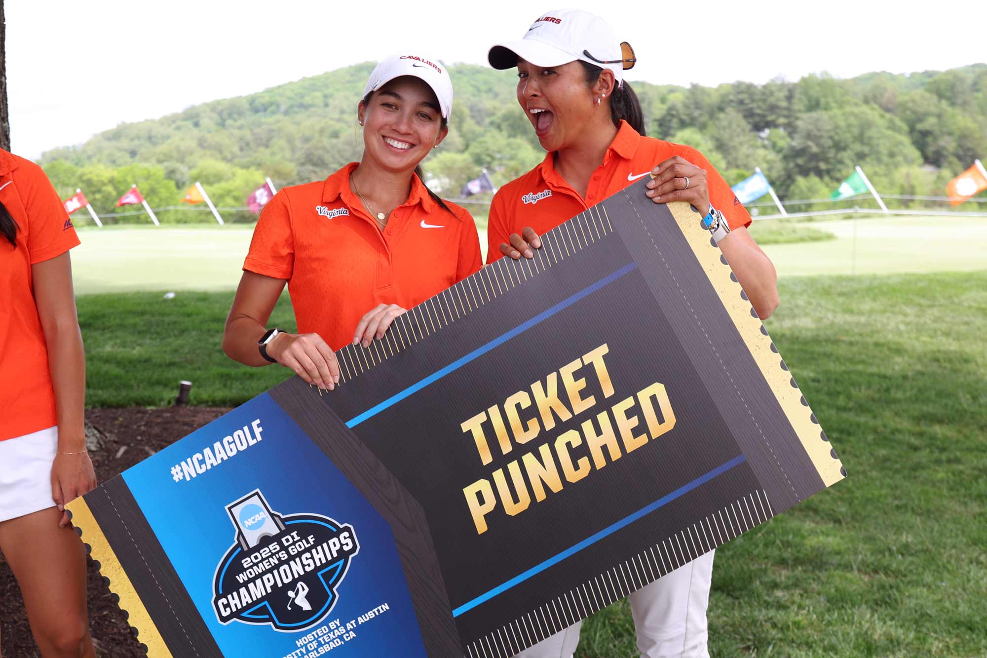 Two UVA women’s golfers holding their oversized ACC tournament ticket