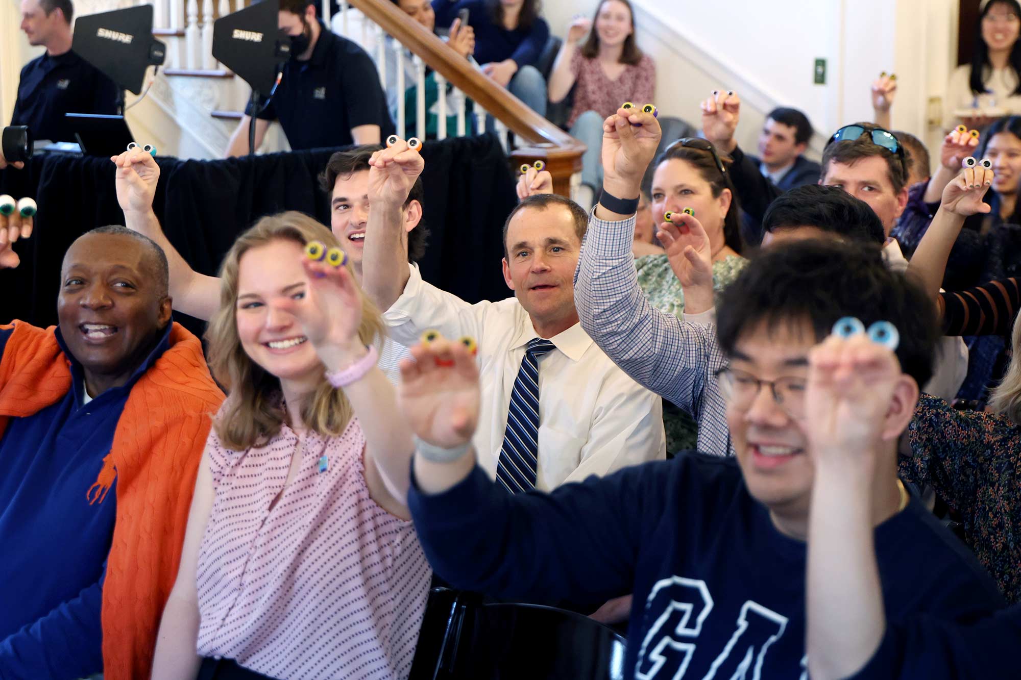 A crowd of people show they "hand" puppets