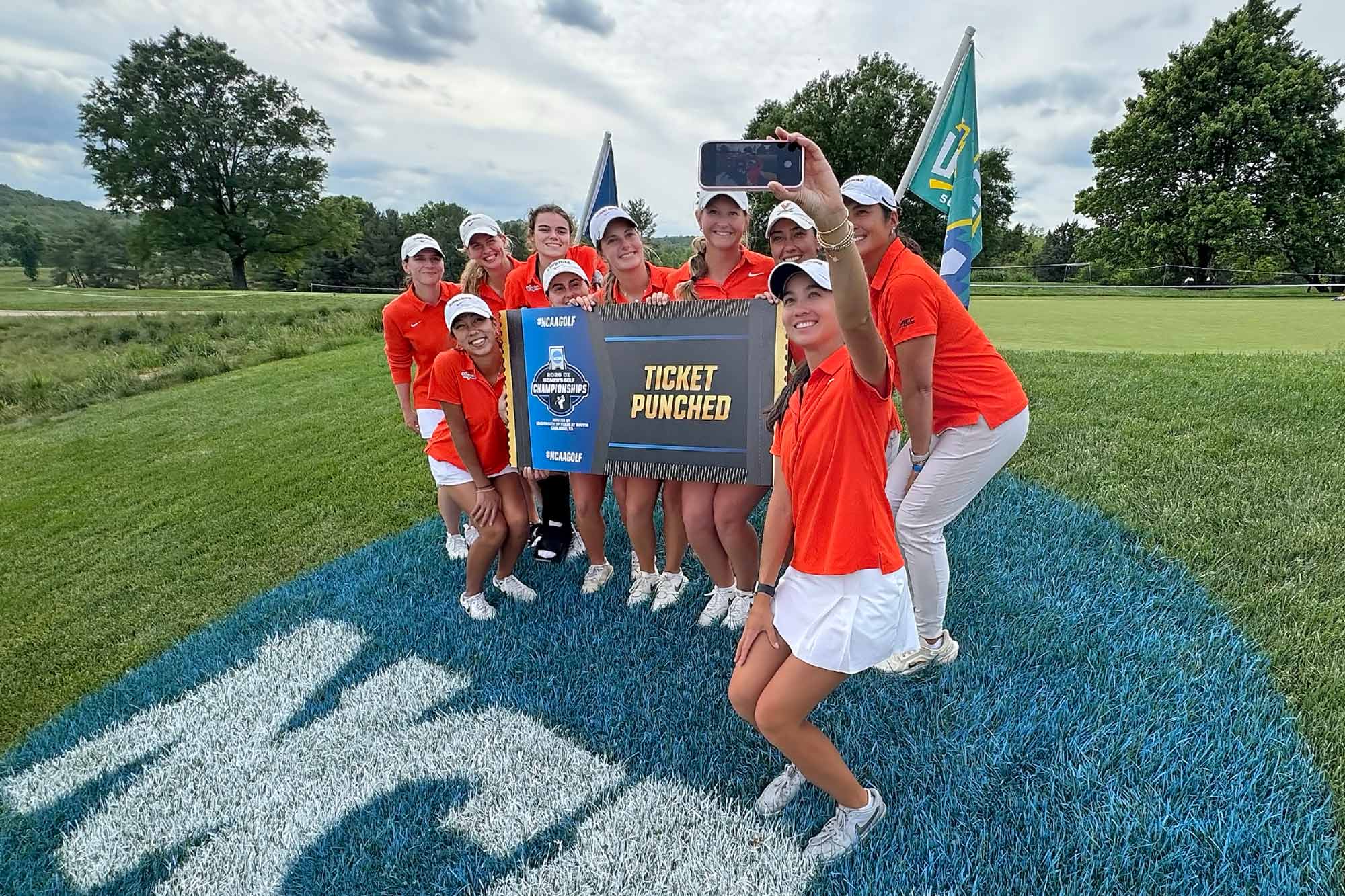 The whole UVA women’s golf team holding an oversized ACC tournament ticket
