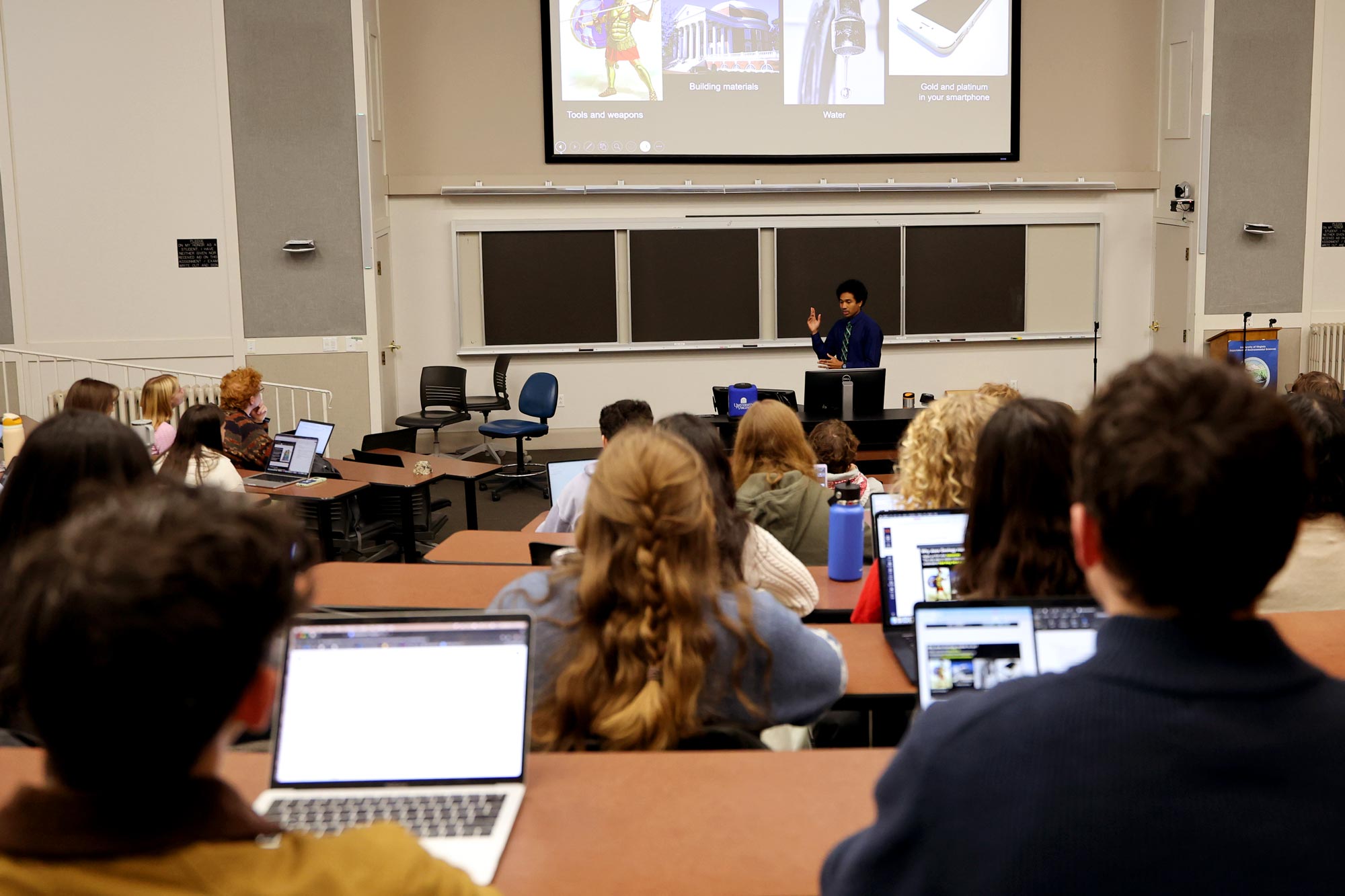 A lecture hall full of students looking at a presentation