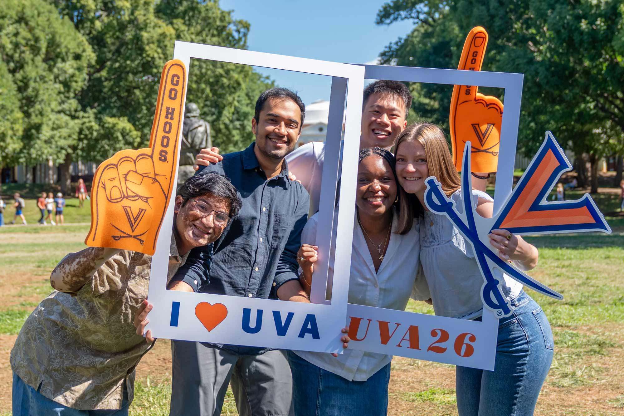 Students pose with frames saying "I love UVA" and #UVA2g" on the Lawn in front of the UVA Rotunda