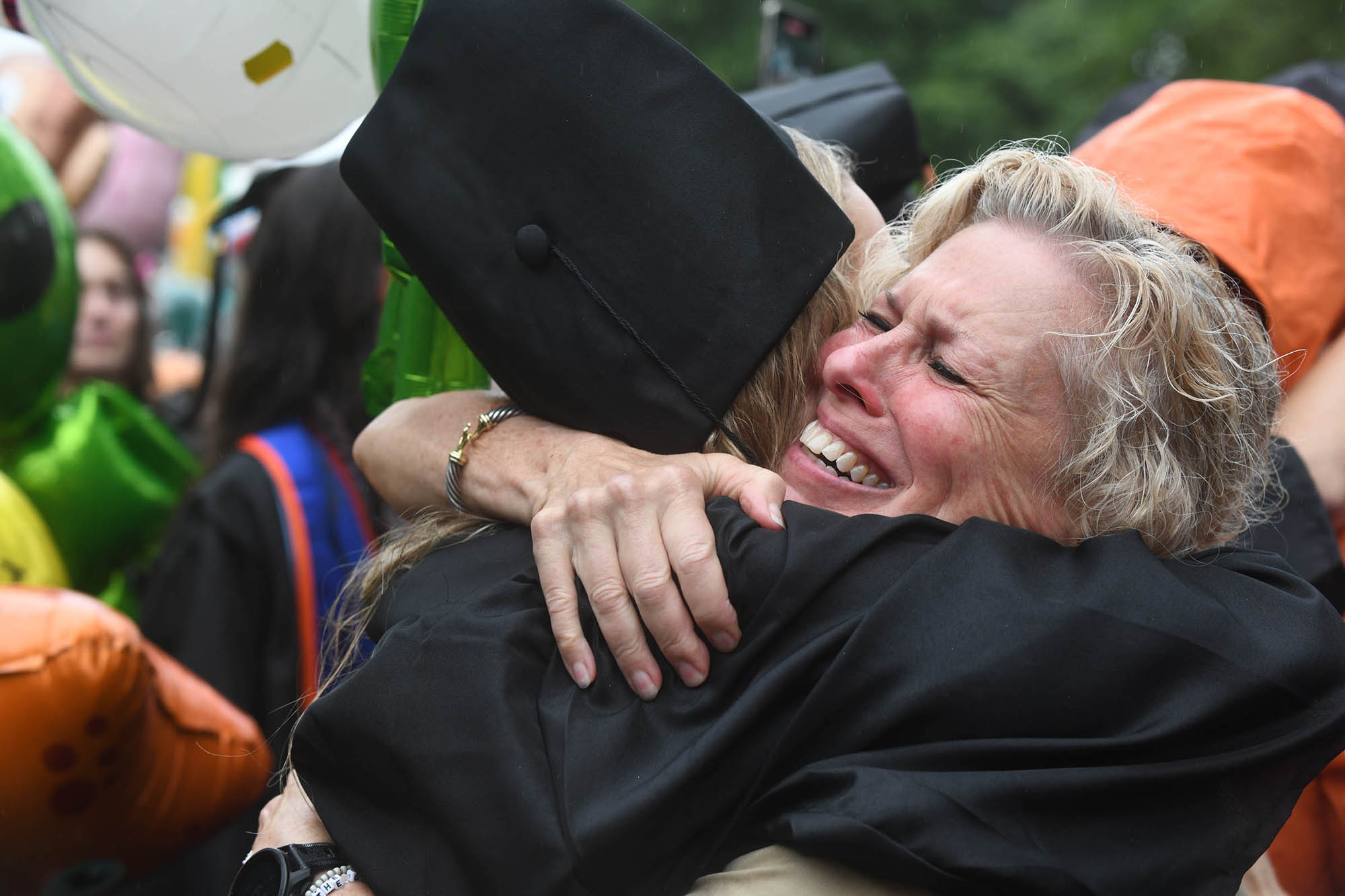 A mom hugs her graduate 