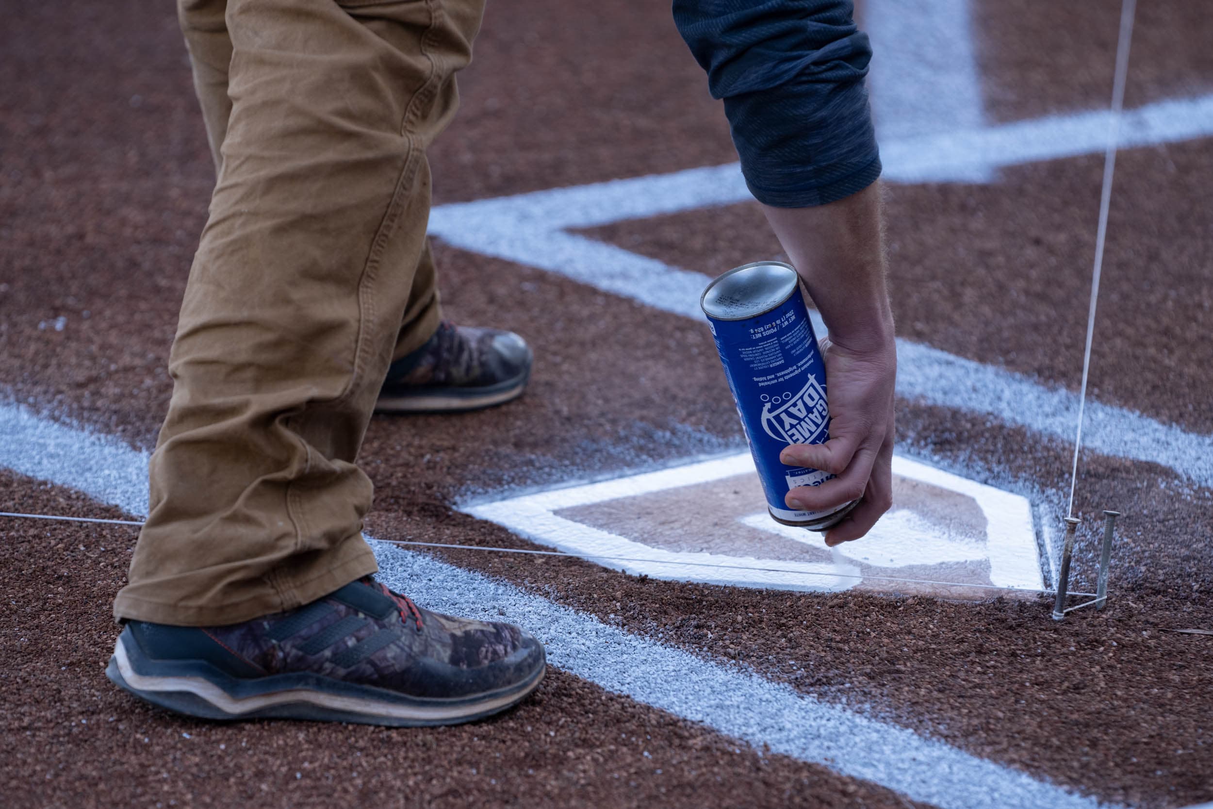 UVA Staff member spraying a base white