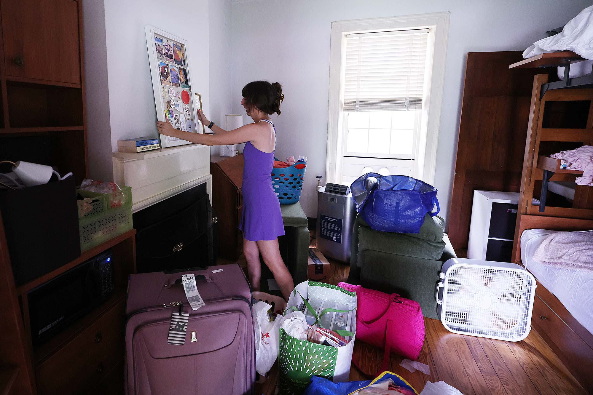  Adan Youngblood organizing her room.