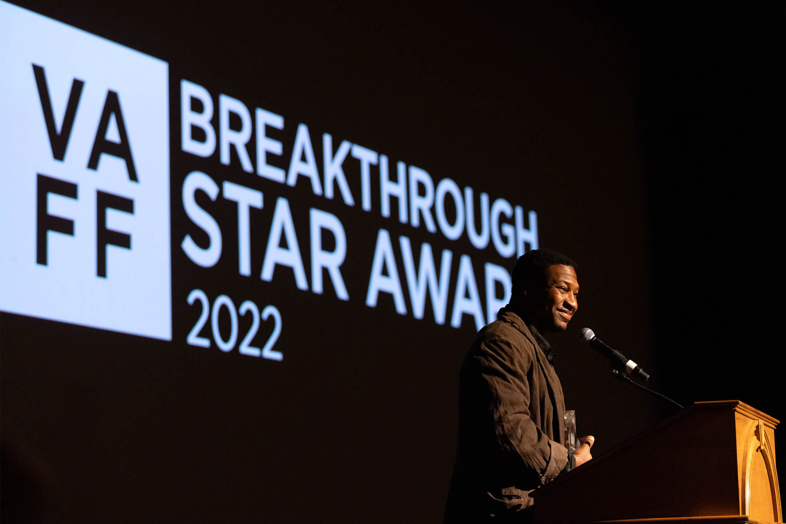 Man speaking from a podium presenting the Breakthrough Star Award for 2022 at the Virginia Film Festival