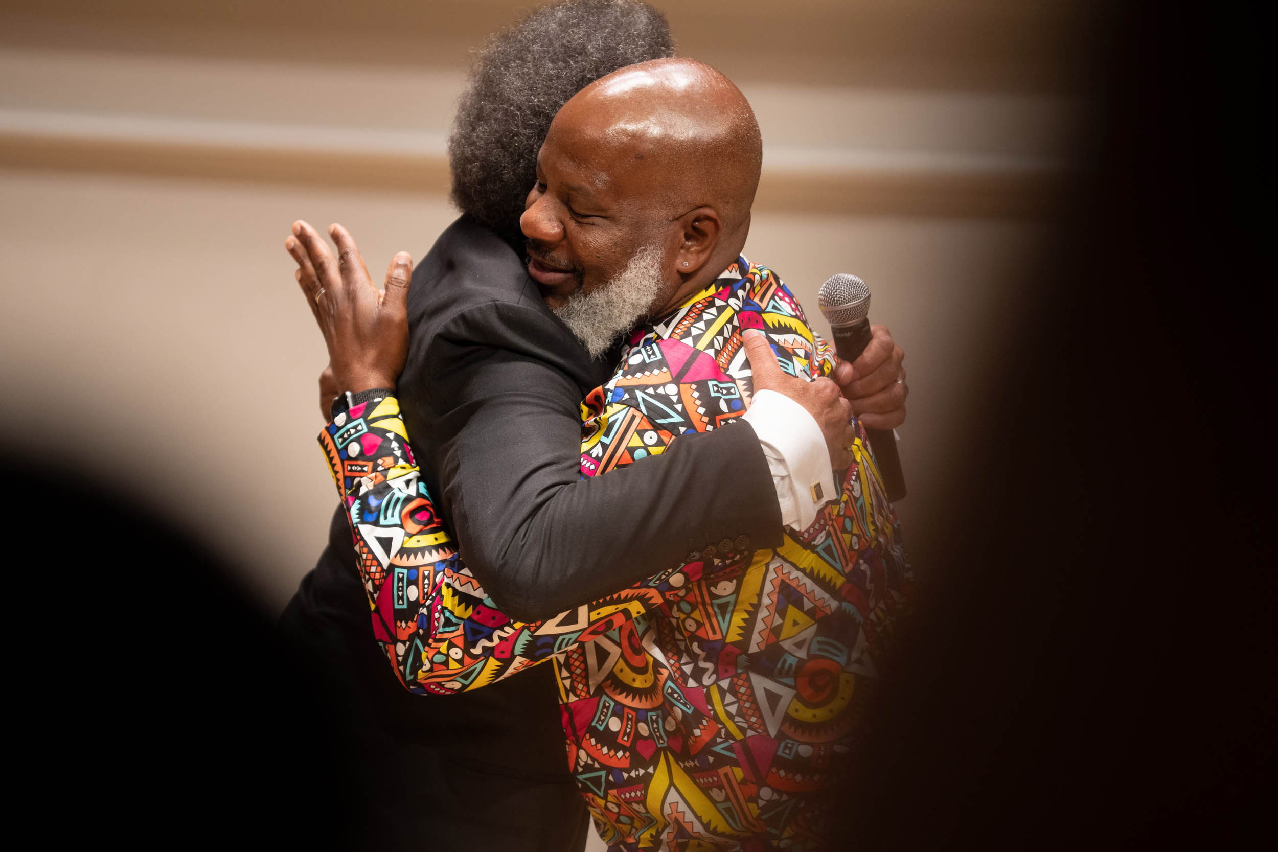 Robert Trent Hugs Cornel West on stage